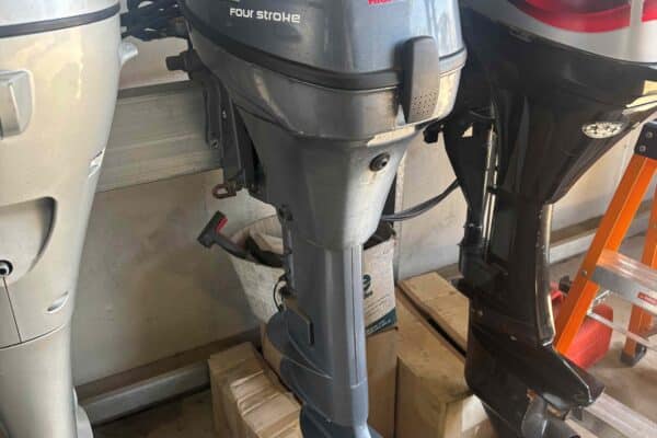 this shows the side of a Yamaha 9.9hp outboard, sitting on an outboard stand