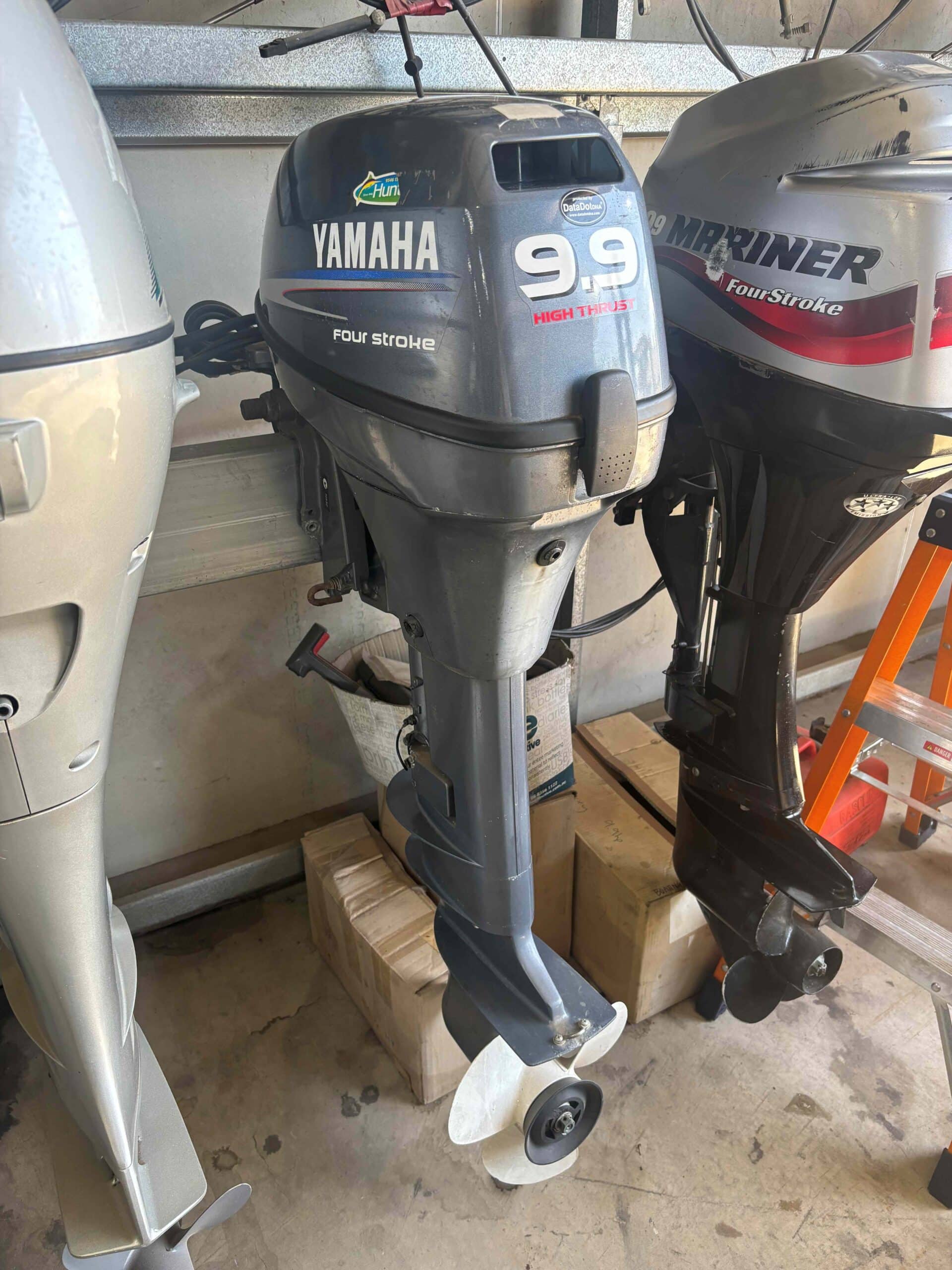 this shows the side of a Yamaha 9.9hp outboard, sitting on an outboard stand