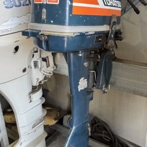 The side of a tohatsu 9.8 horsepower 2 stroke outboard on a motor stand