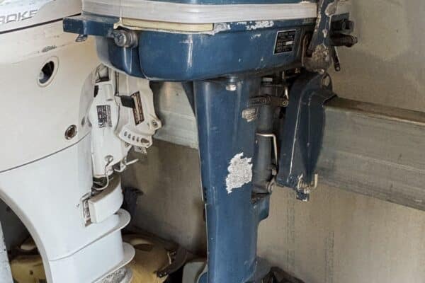 The side of a tohatsu 9.8 horsepower 2 stroke outboard on a motor stand